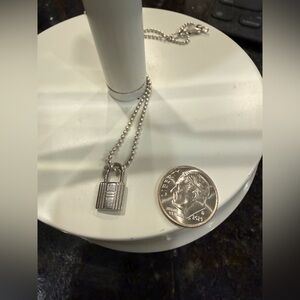 Authentic Hermes dainty charm on a sterling silver chain.